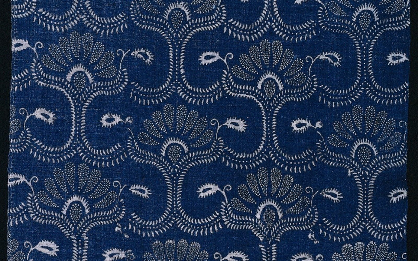 A blue stylized leaf textile pattern