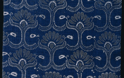 A blue stylized leaf textile pattern